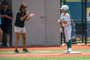 Calvary Softball Coach Tiffany Wood Cheering a softball team member on