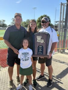 Calvary Softball coach and assistant coach pose with 2025 state champion trophy